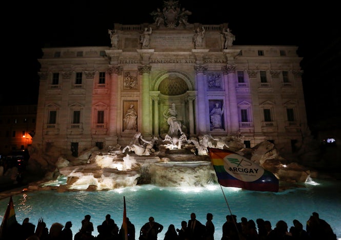 Proyección de luces arcoiris en la Fontana de Trevi para celebrar la ley de uniones civiles en Roma el 11 de mayo de 2016. (REUTERS/Alessandro Bianchi)